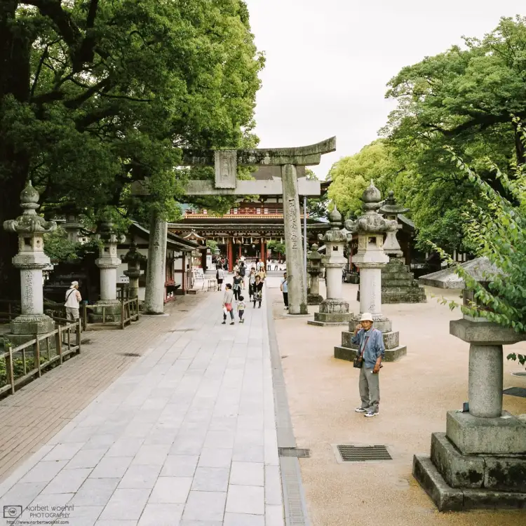 Approaching the Main Gate of Dazaifu Tenmangu Shrine in Fukuoka Prefecture, Japan, this spot between the stone lanterns seems good to make a quick phone call.