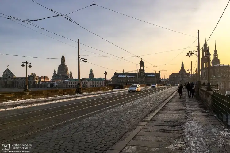 A winter view across Augustusbrücke (Augustus Bridge) in Dresden, Germany. The dome of Frauenkirche is visible at the left.