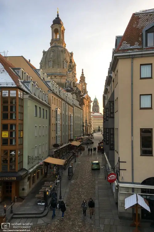 A southbound view along Münzgasse towards the dome of Frauenkirche in Dresden, Germany. The darker tower in the back is part of New City Hall (Neues Rathaus).