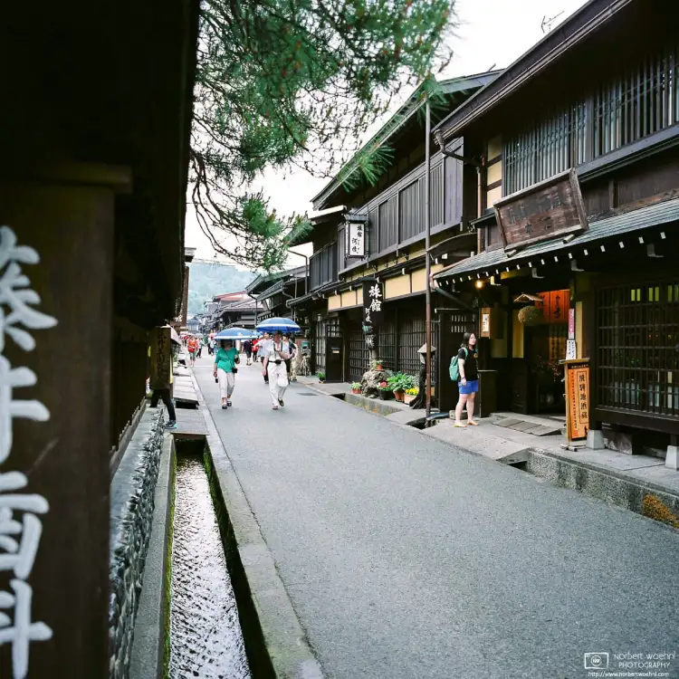 This photo looks along Sannomachi Street in the Old Town of Takayama in Gifu Prefecture, Japan, on a rainy afternoon.