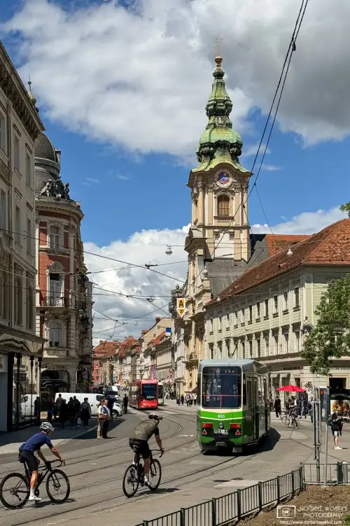 Am Eisernen Tor is a triangular Square in the historic city center of Graz, Austria. The green streetcar is headed into Herrengasse, a pedestrian zone.