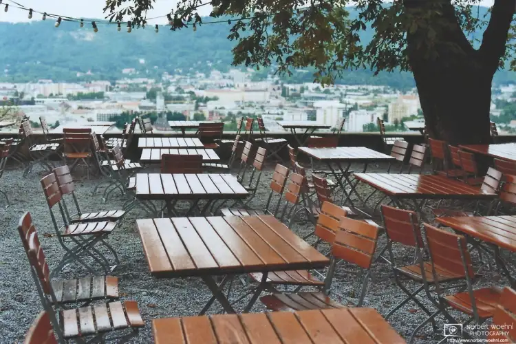 Restaurant tables on the top of Schlossberg Hill in Graz, Austria.