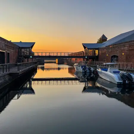 A peaceful scene at dusk in the Kanemori Red Brick Warehouse district of Hakodate in Hokkaido, Japan. The warehouses trace their origins to 1869.