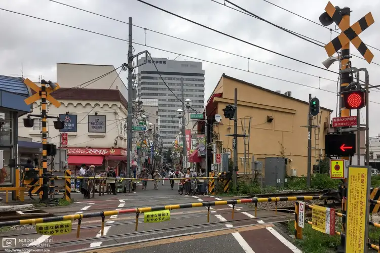 A neighborhood railway crossing at Hatanodai Station in the southeastern part of Tokyo, Japan.