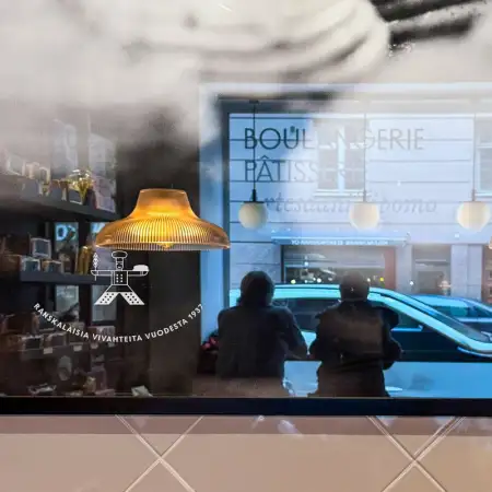 While having lunch at a café in the Kruununhaka district of Helsinki, Finland, I noticed this reflection of other customers in a framed image of pastries.