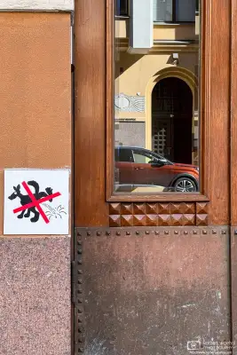 Dog manner sign on a residential building in the Ullanlinna area of Helsinki, Finland