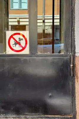Dog manner sign on a residential building in the Ullanlinna area of Helsinki, Finland