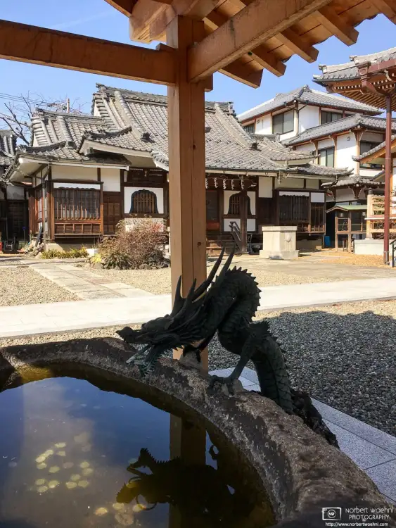 The intricate purification fountain at Myokeiji, a beautiful small temple northeast of Ikebukuro Station in the Toshima Ward of Tokyo, Japan.