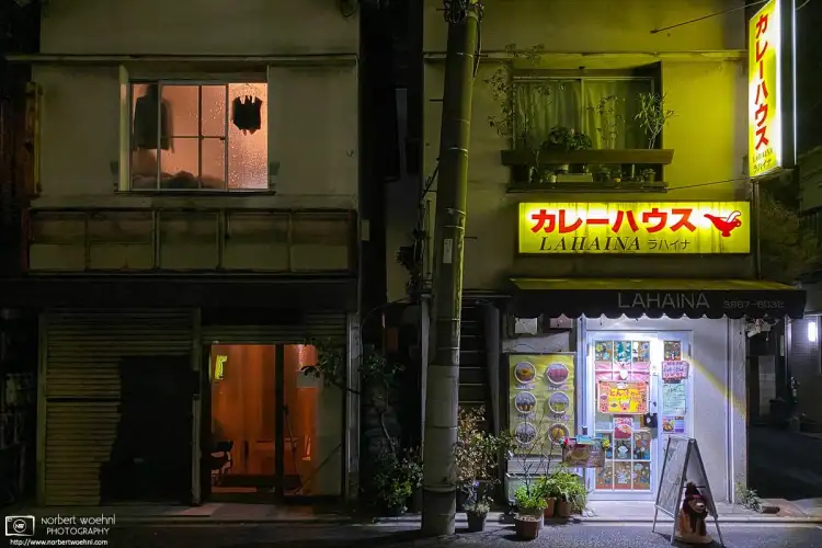 An evening view of the Curry House Lahaina, and a slightly mysterious adjacent building, in the Azusawa neighborhood of Itabashi-ku, Tokyo, Japan.