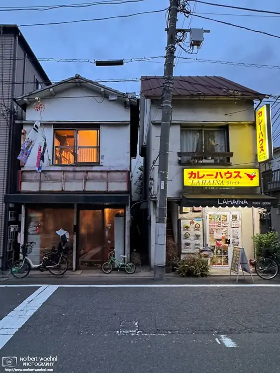 Two buildings in the Azusawa district of Itabashi Ward in Tokyo, Japan. On the right is a Curry Restaurant, on the left is a residential building.