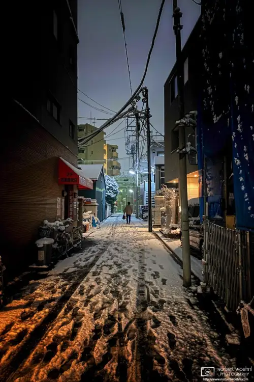 View of a residential side street after a surprise snowfall in the Itabashi Ward of Tokyo, Japan.