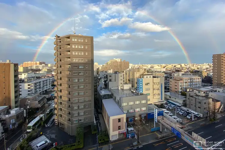 Towards the end of a rain-filled day, a rainbow rises over the eastern part of Itabashi ward in Tokyo, Japan.