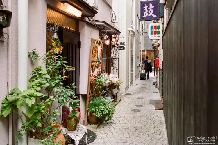 In the Kagurazaka area near Iidabashi Station in Tokyo, Japan, this is a view into a colorful narrow alley with an inviting-looking shop entrance.