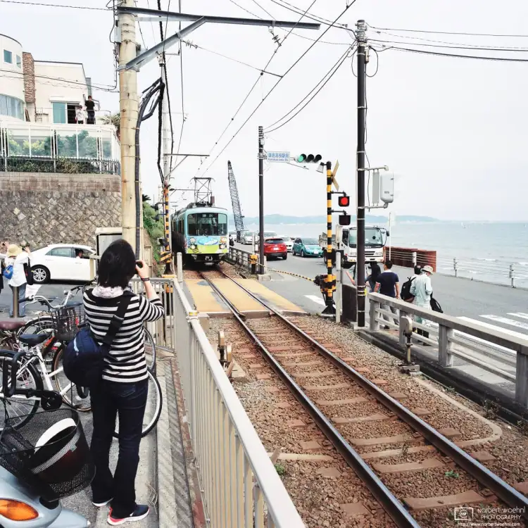 An Enoshima Electric Railway Train approaches Kamakurakokomae Station in Kamakura, Japan.