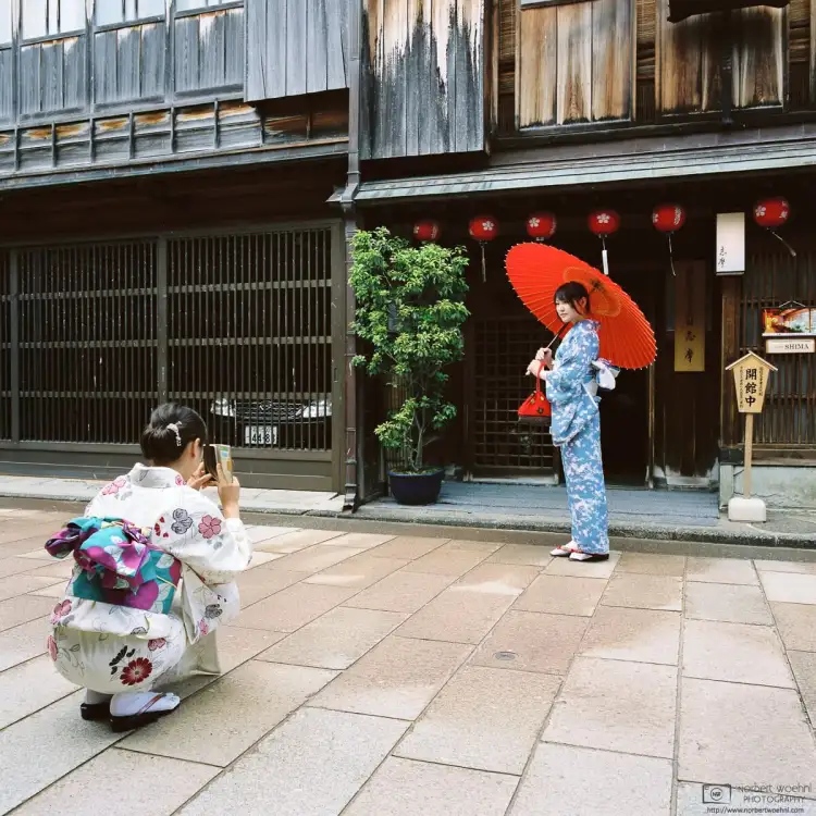 Walking around Higashi Chayagai, a historic district in Kanazawa, Japan, I saw two young women in kimono emerging from one of the old buildings.