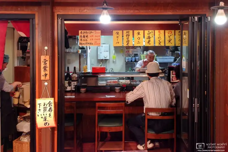 View into a small seafood restaurant inside Omicho Market in Kanazawa, Japan.