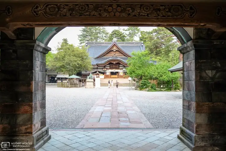 A view towards the Main Hall of Oyama Jinja in Kanazawa, Japan, while entering the main yard through the shrine's distinctive Main Gate.