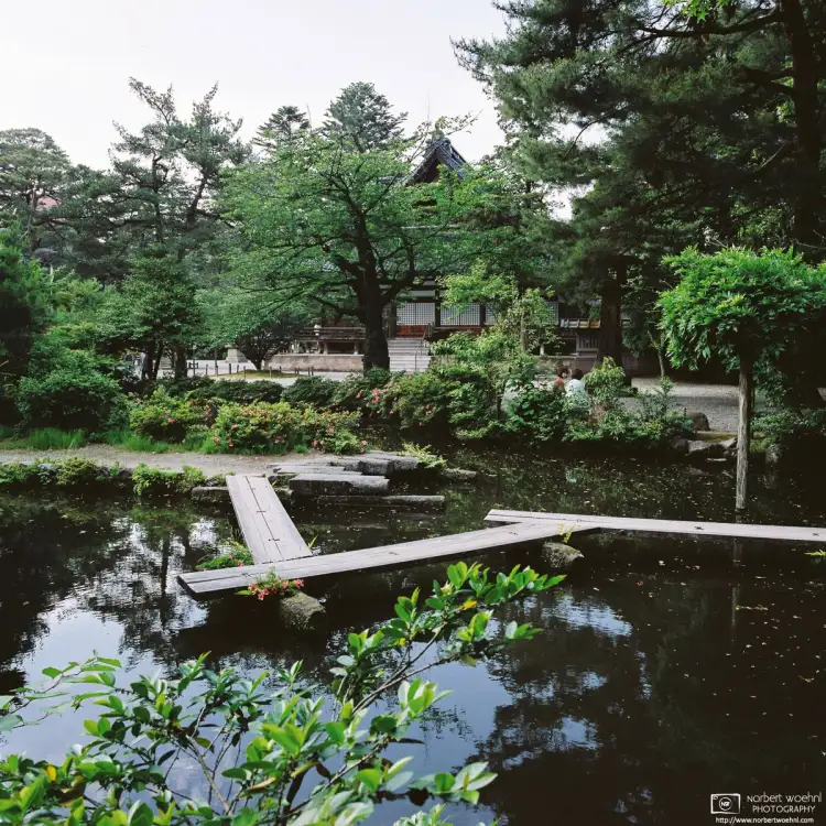 At Oyama Shrine in Kanazawa, Ishikawa Prefecture, Japan, this view looks across a small pond towards the main hall.