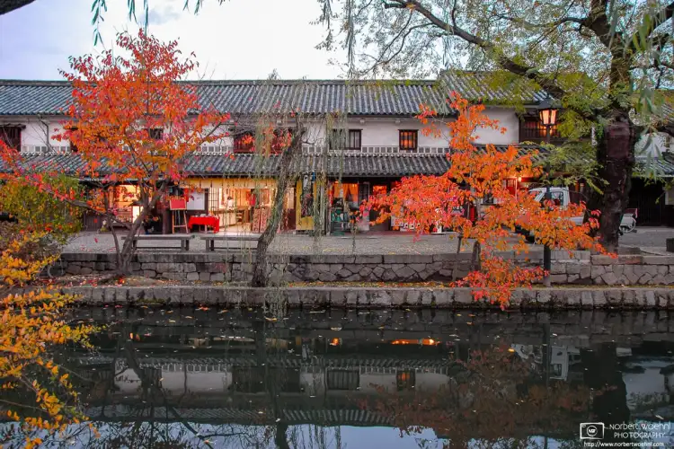 During autumn season, this is a view across the canal in the historic Bikan district of Kurashiki in Okayama Prefecture, Japan.