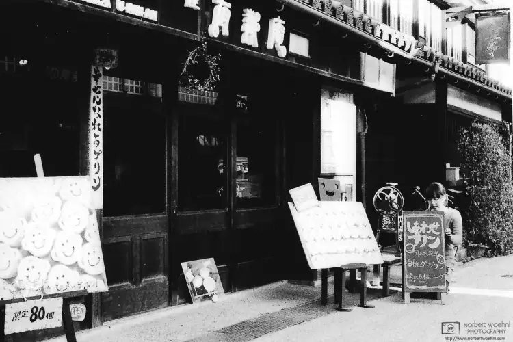 In the historic Bikan District of Kurashiki in Okayama Prefecture, Japan, a café waitress is updating the specials board.