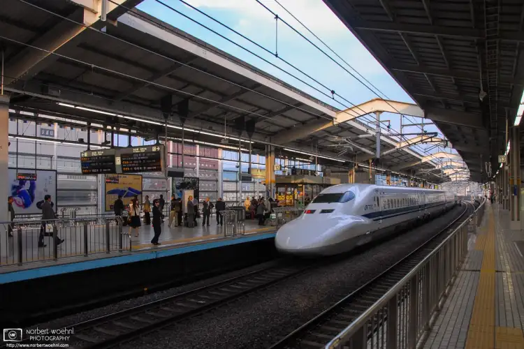 A Nozomi Shinkansen (bullet train) is seen departing from track 12 at Kyoto Station, Japan.