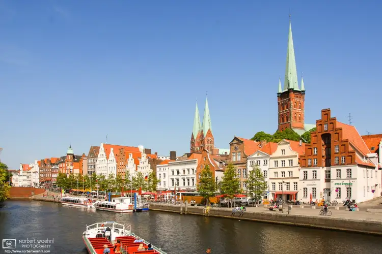 A view towards the historic city center of Lübeck, Germany, from a tour boat on the Trave River.