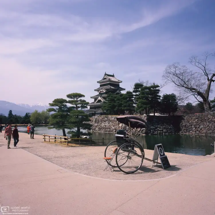 A Jinricksha waiting for the next customer tour outside Matsumoto Castle in Nagano Prefecture, Japan.