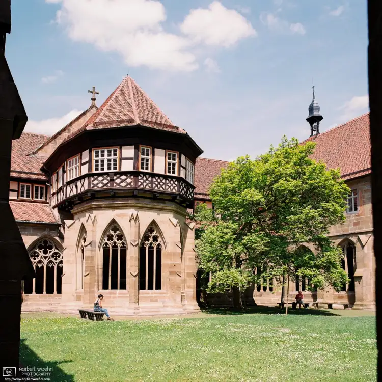 Shot through a stone window at the corner of the cloister, this is a view of the Fountain House at Maulbronn Monastery in Southwestern Germany.