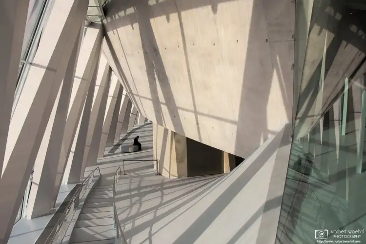 A museum attendant is taking a contemplative break at the Mercedes-Benz Museum in Stuttgart, Germany.