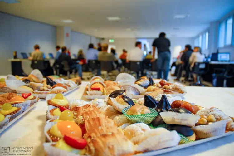 Sweet treats are laid out on a table in the back of a meeting room for the participants of a business workshop in Milan, Italy.