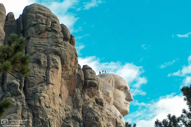 National Park staff inspecting the head of George Washington at Mount Rushmore National Memorial, South Dakota.