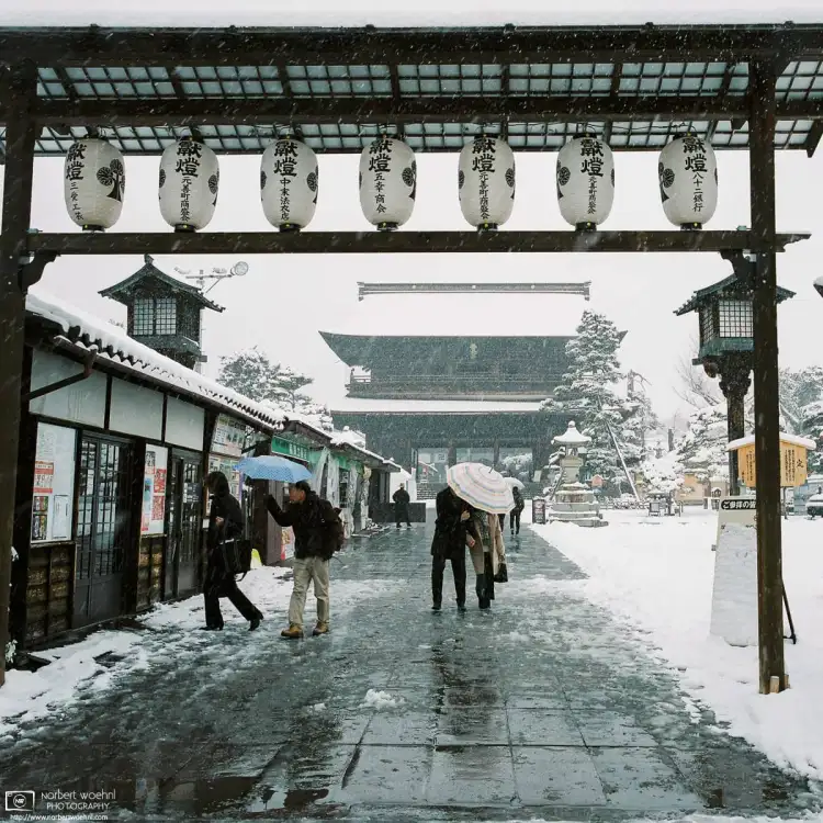 Visitors defying the snowy weather at Zenkōji Temple in Nagano, Japan.