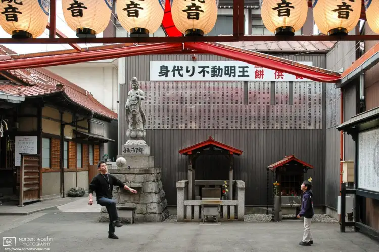 On a walk through the Ōsu area of Nagoya, Japan, I ran into this scene of a father and son playing football outside the small Banshō-ji Temple.