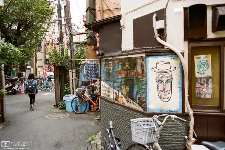 A makeshift exhaust pipe and a brick-pattern shirt are just two of the many details in this scene from a street corner in Nakano, Tokyo, Japan.