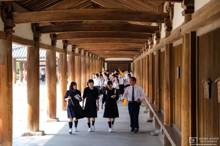 Students are seen taking a guided tour at Hōryūji Temple in Nara, Japan.