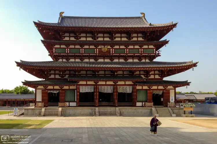 In the late afternoon, a priest is seen walking away from the Golden Hall at Yakushiji Temple in Nara, Japan.