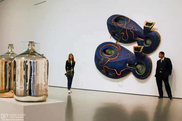 A visitor and a museum attendant are focusing their interests in this shot from the MoMA in New York City.