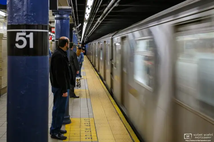 An E Train is seen arriving at Lexington Ave/51st Street Subway Station in Manhattan, New York.