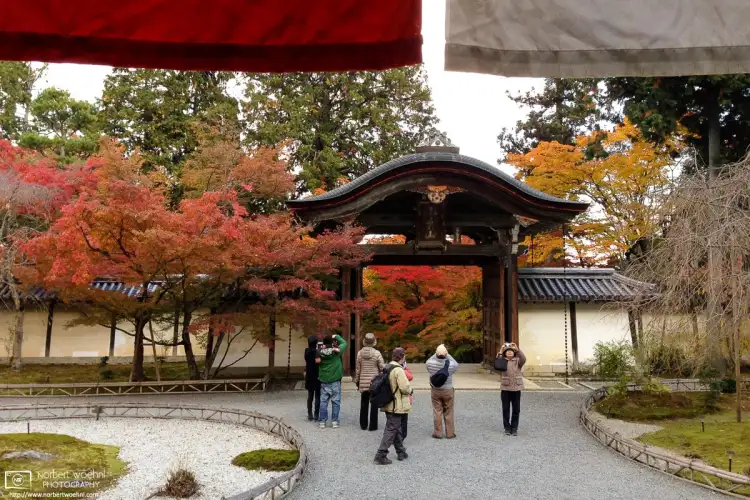 Visitors outside the main hall of Nisonin, a Tendai Buddhist temple complex in the Sagano area of western Kyoto, Japan.