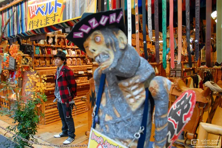A fashion-conscious attendant is waiting for customers in a shopping street of the Osu district in Nagoya, Japan.