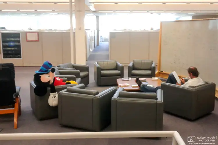 An exhausted Mickey Mouse is getting some rest at a sitting area inside a corporate office in Palo Alto, California.