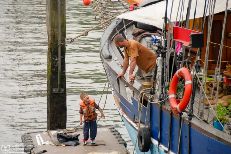 Walking around a small boat harbor in Rotterdam, The Netherlands, I ran into a discussion between father and son.