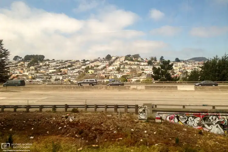 Scenery outside a BART train between downtown San Francisco and SFO Airport. This view looks across I-280 towards the Oceanview district.