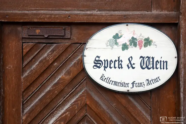 A sign advertising the sale of bacon and wine (Speck & Wein) in the village of Sankt Margarethen in eastern Austria.