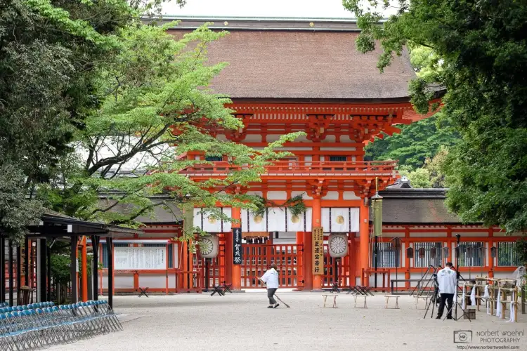 Temple staff is performing some final cleaning outside Shimogamo Shrine on the day of the Aoi Matsuri, a major festival held every year in Kyoto, Japan.
