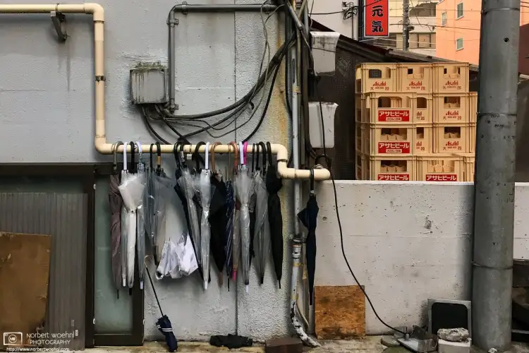 A still life of umbrellas and beer crates in the Taito Ward of Tokyo, Japan. Taken on a photo walk in 2018 with photographer Alfie Goodrich.