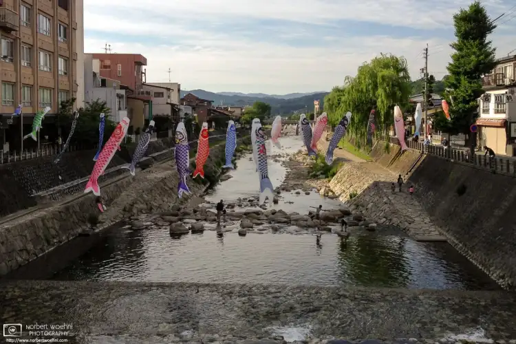 Koinobori (carp-shaped windsocks) are hung across the Miyagawa River in the city of Takayama, Gifu Prefecture, Japan.