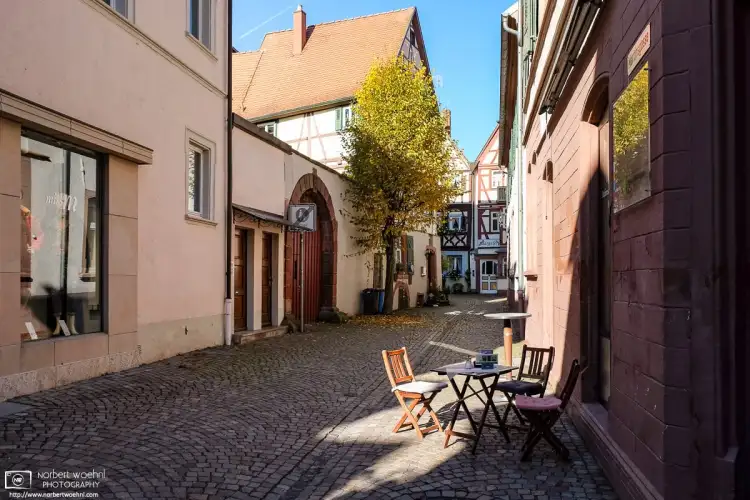 A street cafe table on a quiet side street in the historic city center of Tauberbischofsheim in the southwest-German state of Baden-Württemberg.