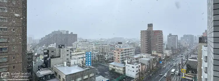 Panoramic photo of an urban scenery with mixed-use buildings in the Itabashi Ward of Tokyo, Japan, during snowy weather.
