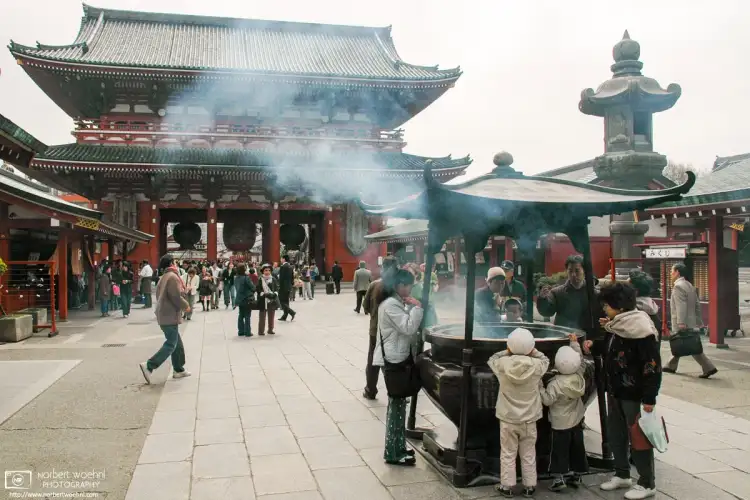 Visitors are burning incense on the premises of Senso-ji Temple in the Asakusa district of Tokyo, Japan.